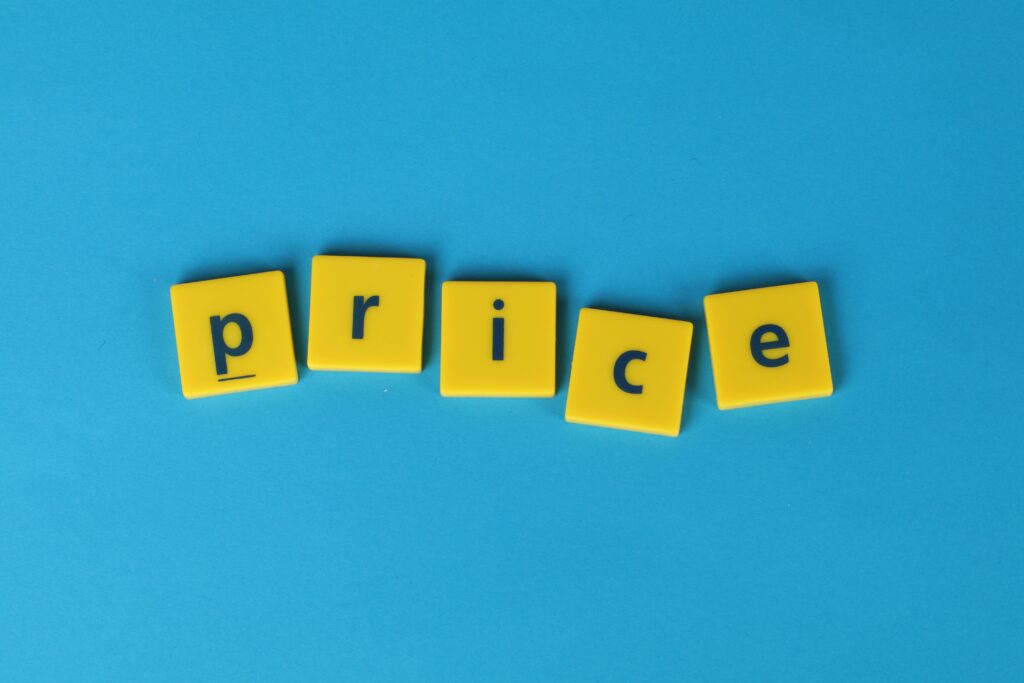 Yellow letter tiles spell the word 'price' against a vibrant blue backdrop, ideal for business concepts.